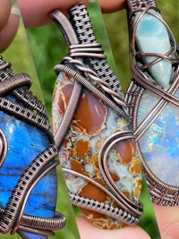 three wire wrapped pendants with different colored stones