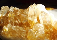 a close up of a cluster of yellow crystals